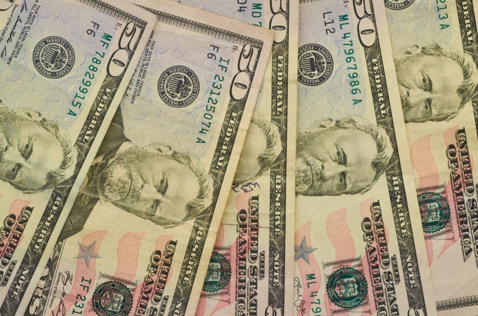 Free Image of Many twenty and fifty US dollar bills laid out flat 