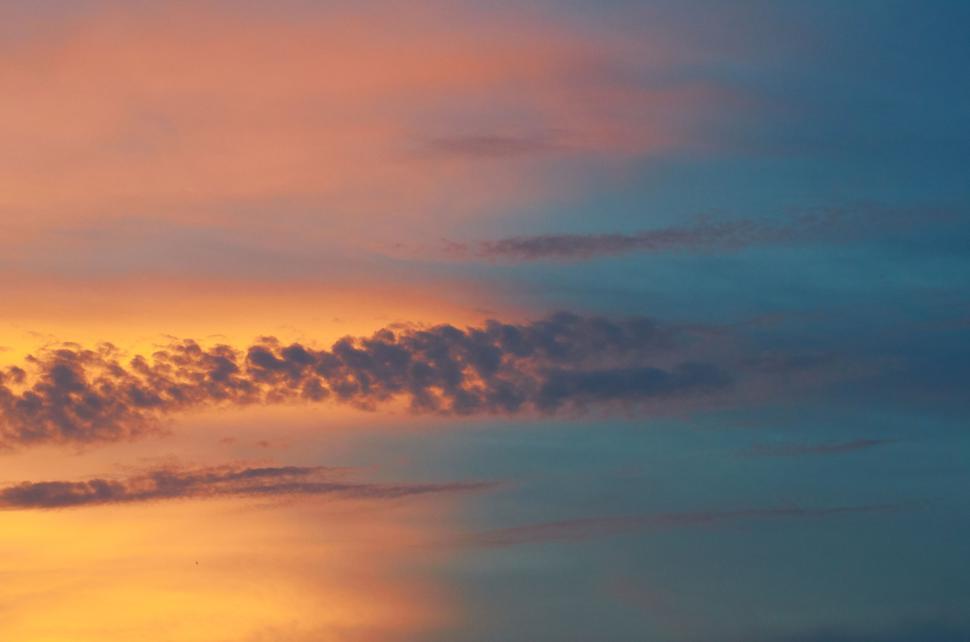 Free Image of Vibrant sunset with a mix of blue and yellow colors 