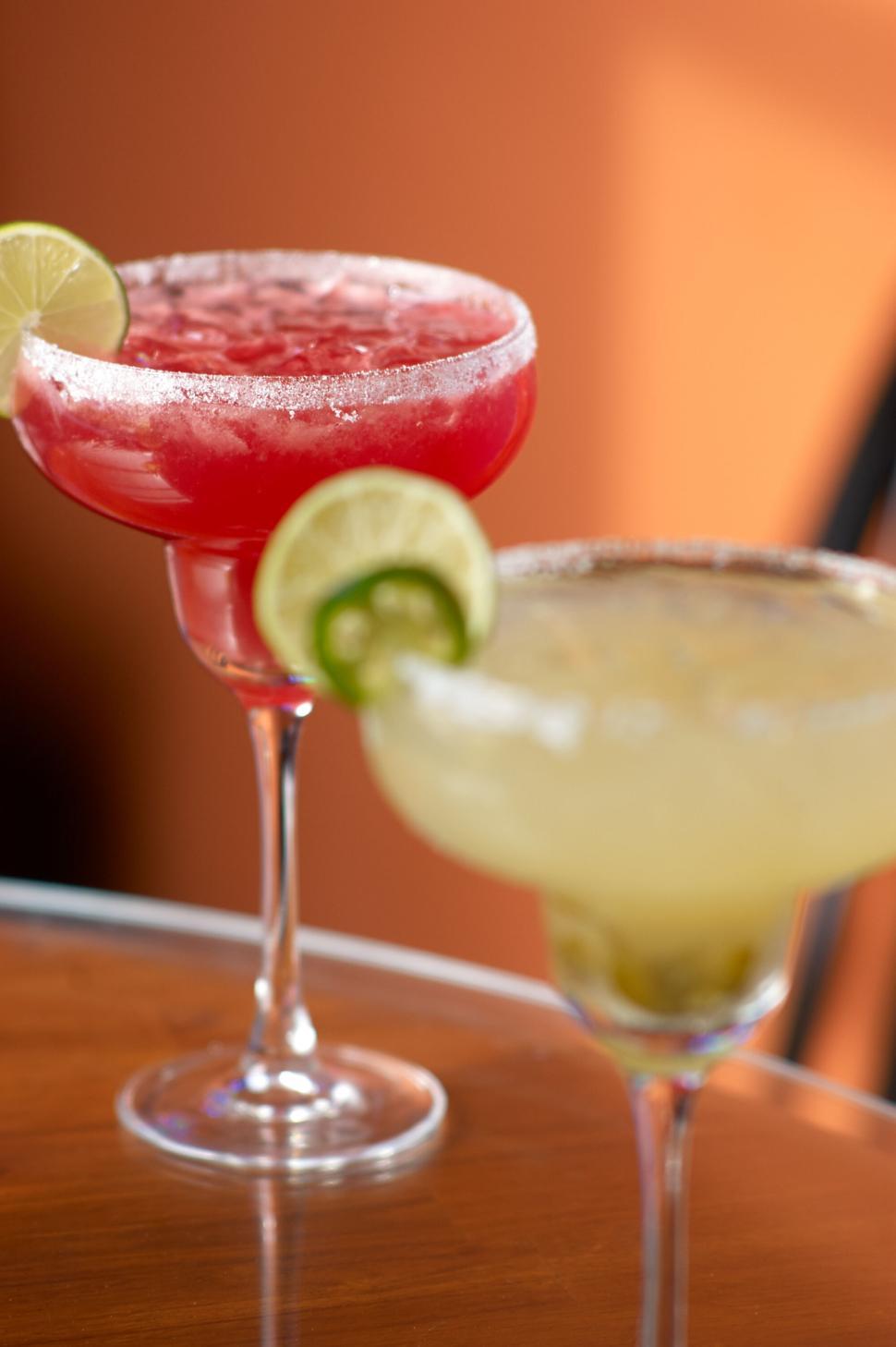 Free Image of Two cocktails with lime slices on a wooden table. 