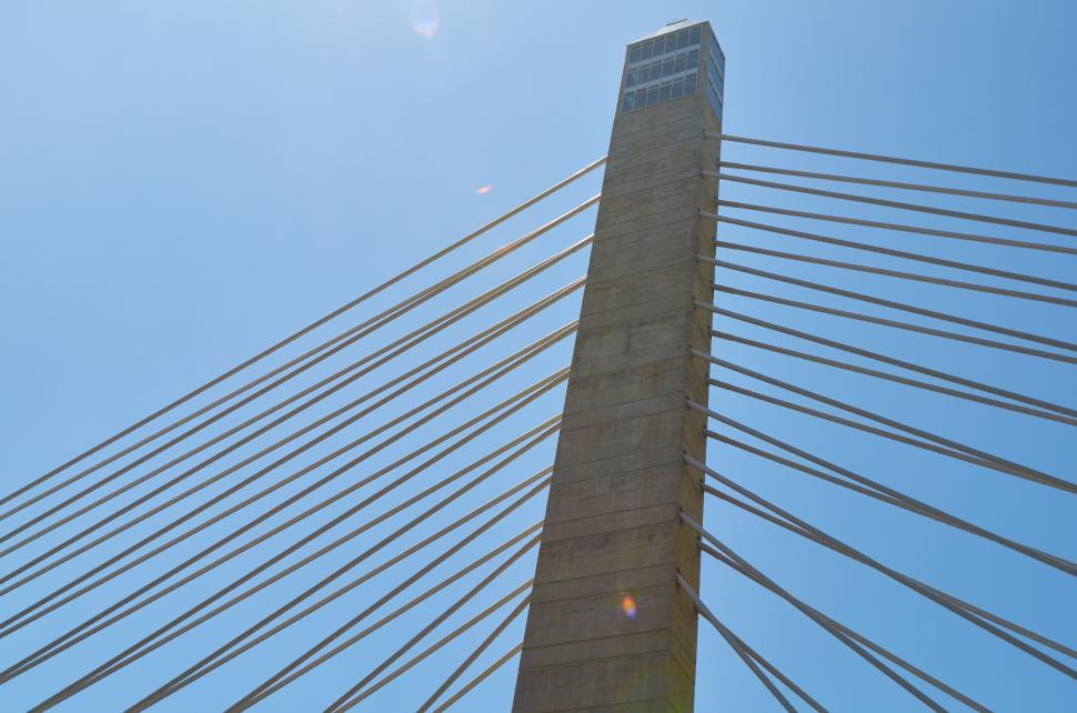 Free Image of Tall bridge tower with suspension cables and blue sky 