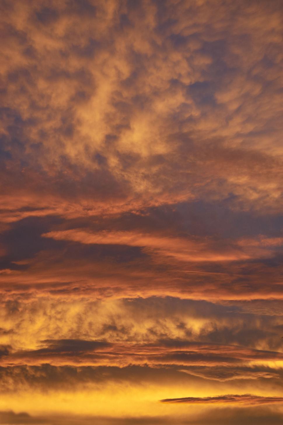 Free Image of Magnificent sunset sky filled with warm toned clouds. 