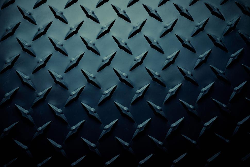 Free Image of Close-up of dark, patterned metal surface texture. 