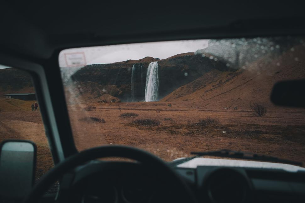Free Image of Waterfall viewed through the windshield of a vehicle 