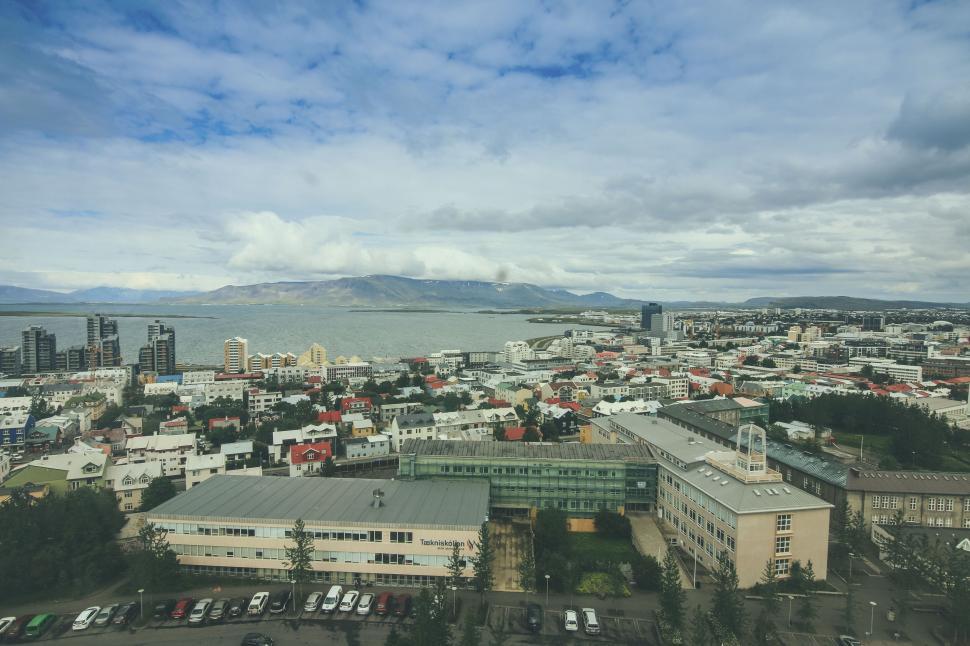 Free Image of Aerial view of coastal city with mountains in the background 