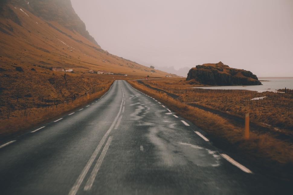 Free Image of Deserted road through a desolate landscape on misty day. 