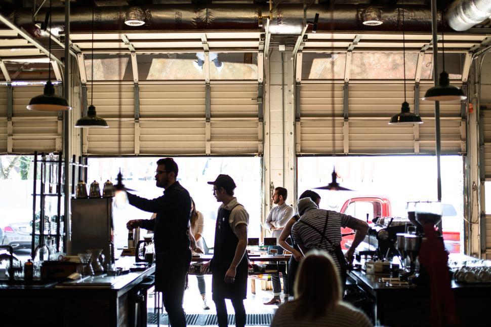 Free Image of People working in industrial-themed cafe or coffee shop. 