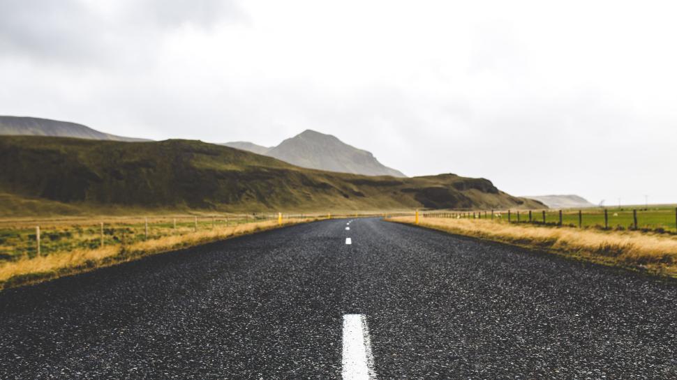 Free Image of Empty Road Stretching Into the Distant Mountains 