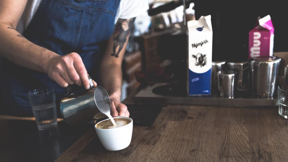 Free Image of Barista Pouring Milk into a Freshly Brewed Coffee Cup 