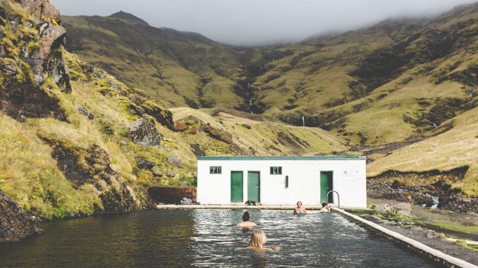 Free Image of Outdoor Pool with People Swimming in Scenic Mountains 