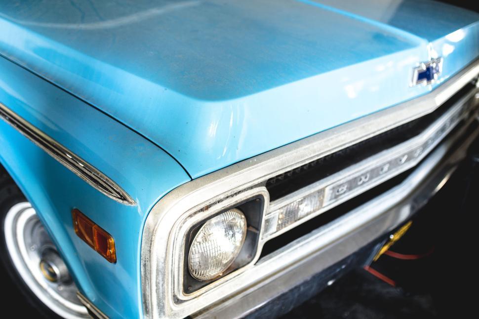Free Image of Close-up of vintage blue car showcasing headlight detail. 