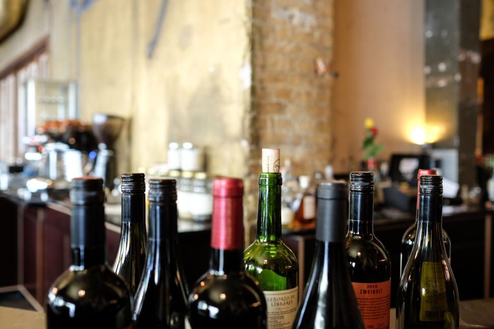 Free Image of Collection of wine bottles in a modern rustic kitchen 