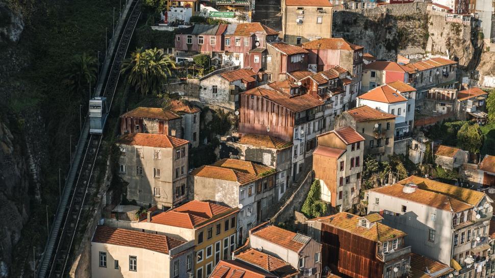Free Image of Rustic hillside village with colorful rooftops and houses. 