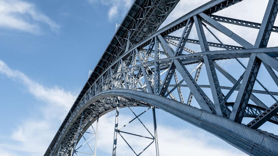 Free Image of Tall industrial steel bridge under a blue sky view. 