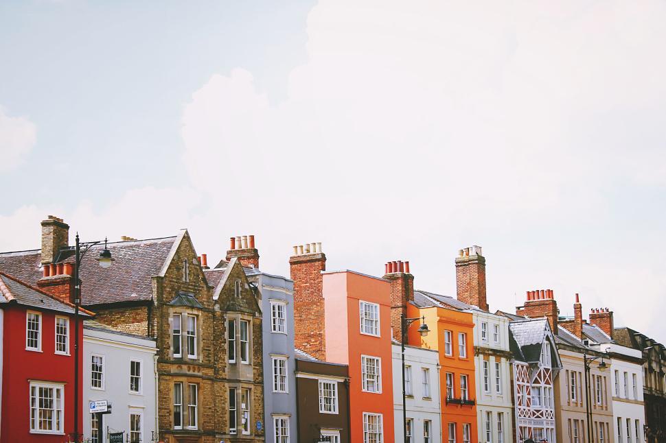 Free Image of Colorful heritage houses in a row under a cloudy sky 