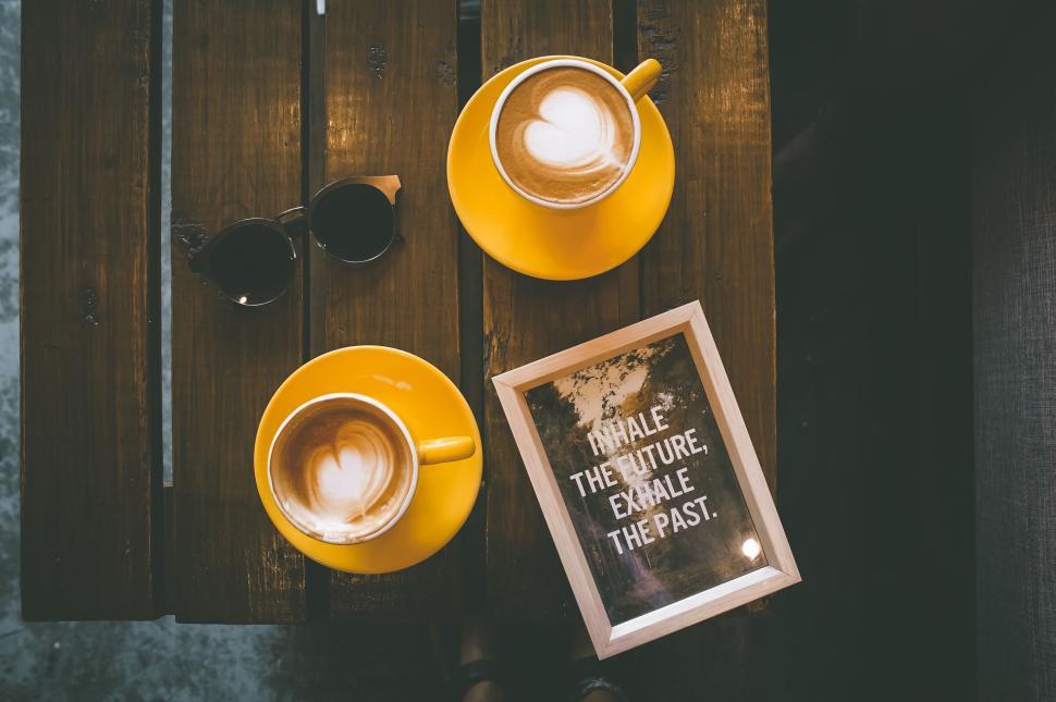 Free Image of Two cups of cappuccino on wooden table with positive quote 
