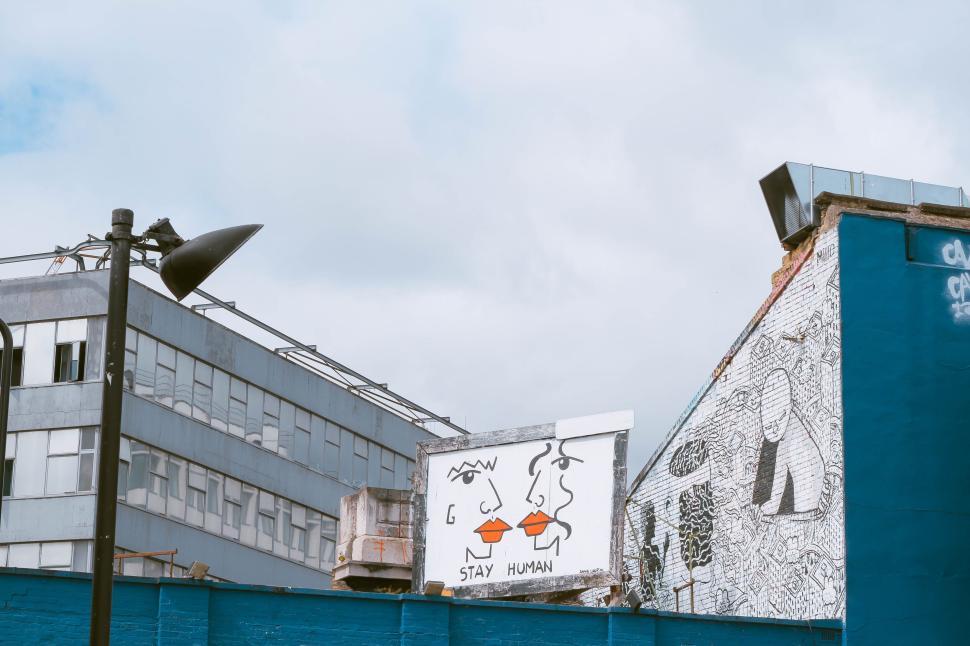 Free Image of Street art mural on building with  Stay Human  message. 