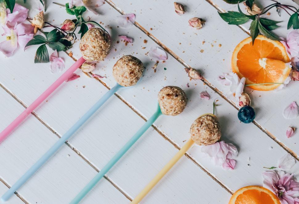 Free Image of Elegant energy balls on pastel straws with orange slices 