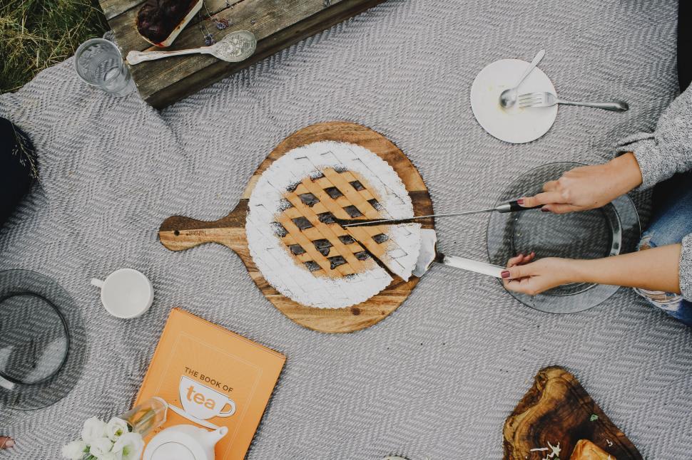 Free Image of Picnic setup with a pie on a blanket and cozy vibes. 