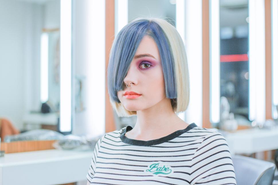 Free Image of Woman with colorful hairstyle in contemporary salon setting 