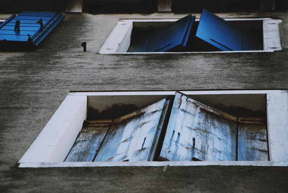 Free Image of Old, rustic windows with blue shutters partially opened 