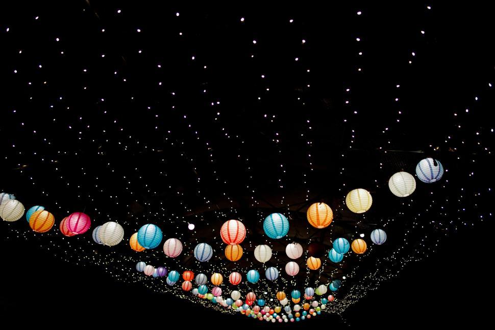 Free Image of Colorful hanging lanterns against a dark background. 