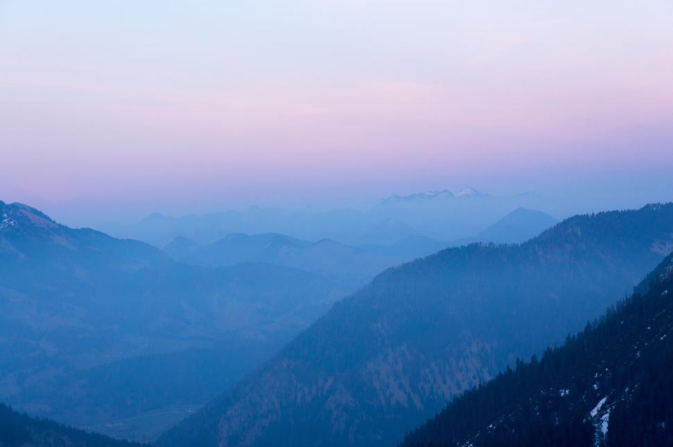 Free Image of Pastel colored mountains with a gradient sky at sunset. 