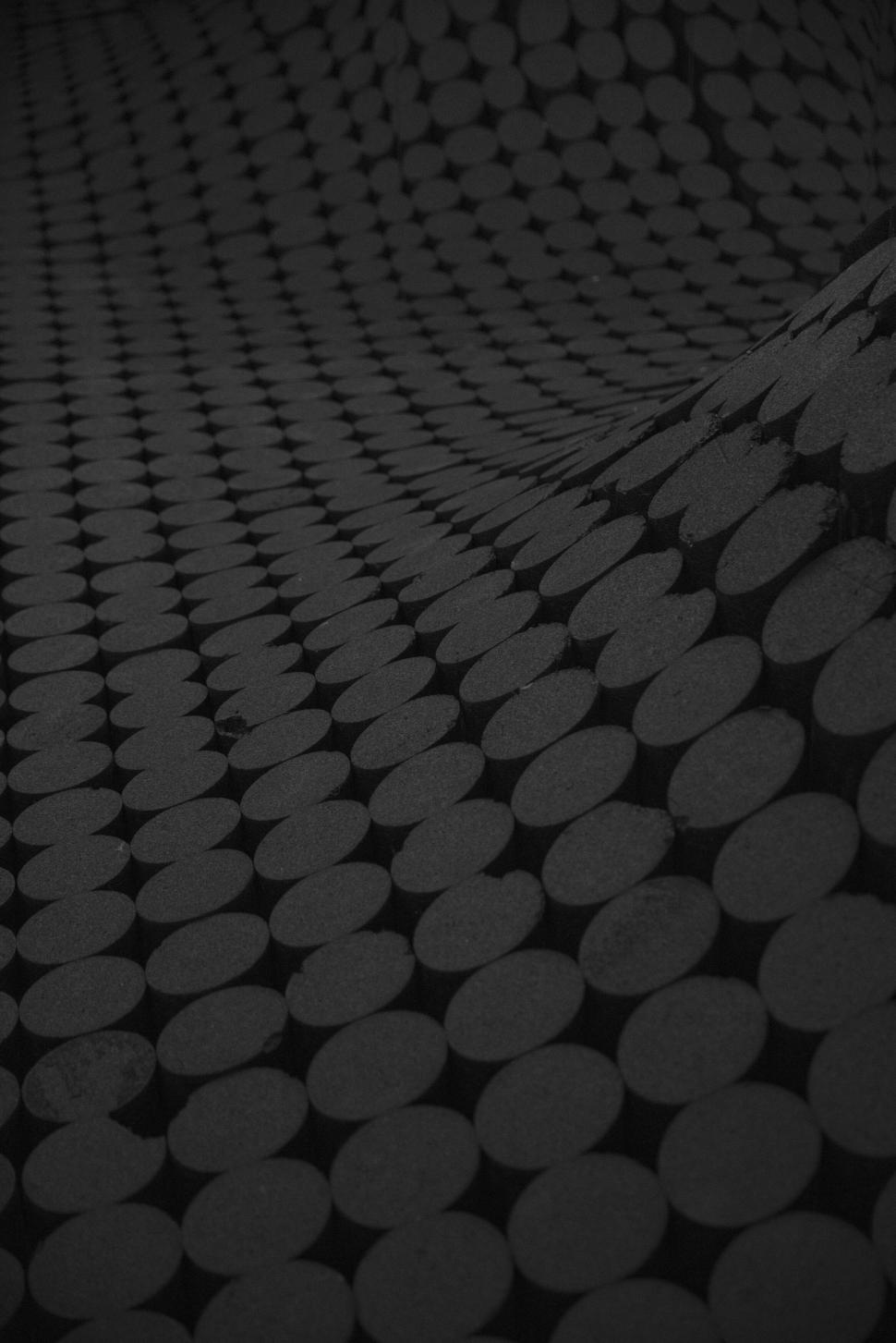 Free Image of Abstract dark pattern of circular shapes in gradient curve. 