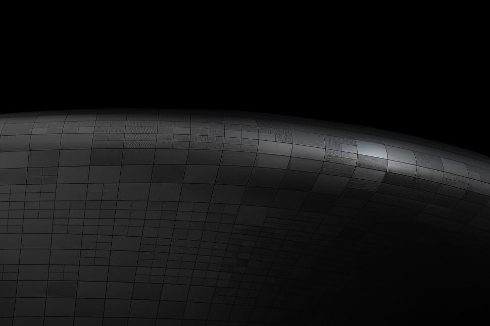 Free Image of Curved modern architectural structure with grid pattern. 