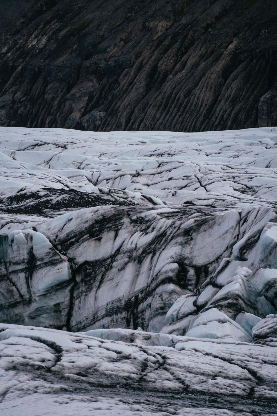 Free Image of Jagged iceberg glacier with deep crevices and fissures 