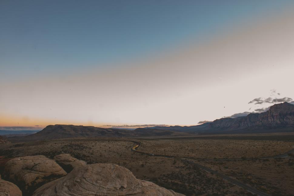Free Image of Vast, serene desert landscape under a beautiful twilight sky. 