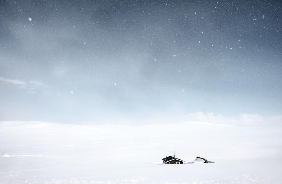 Free Image of Snow-covered landscape with partially buried houses. 