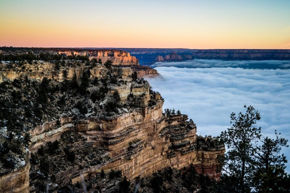 Free Image of Grand Canyon enveloped in low lying clouds at sunrise. 