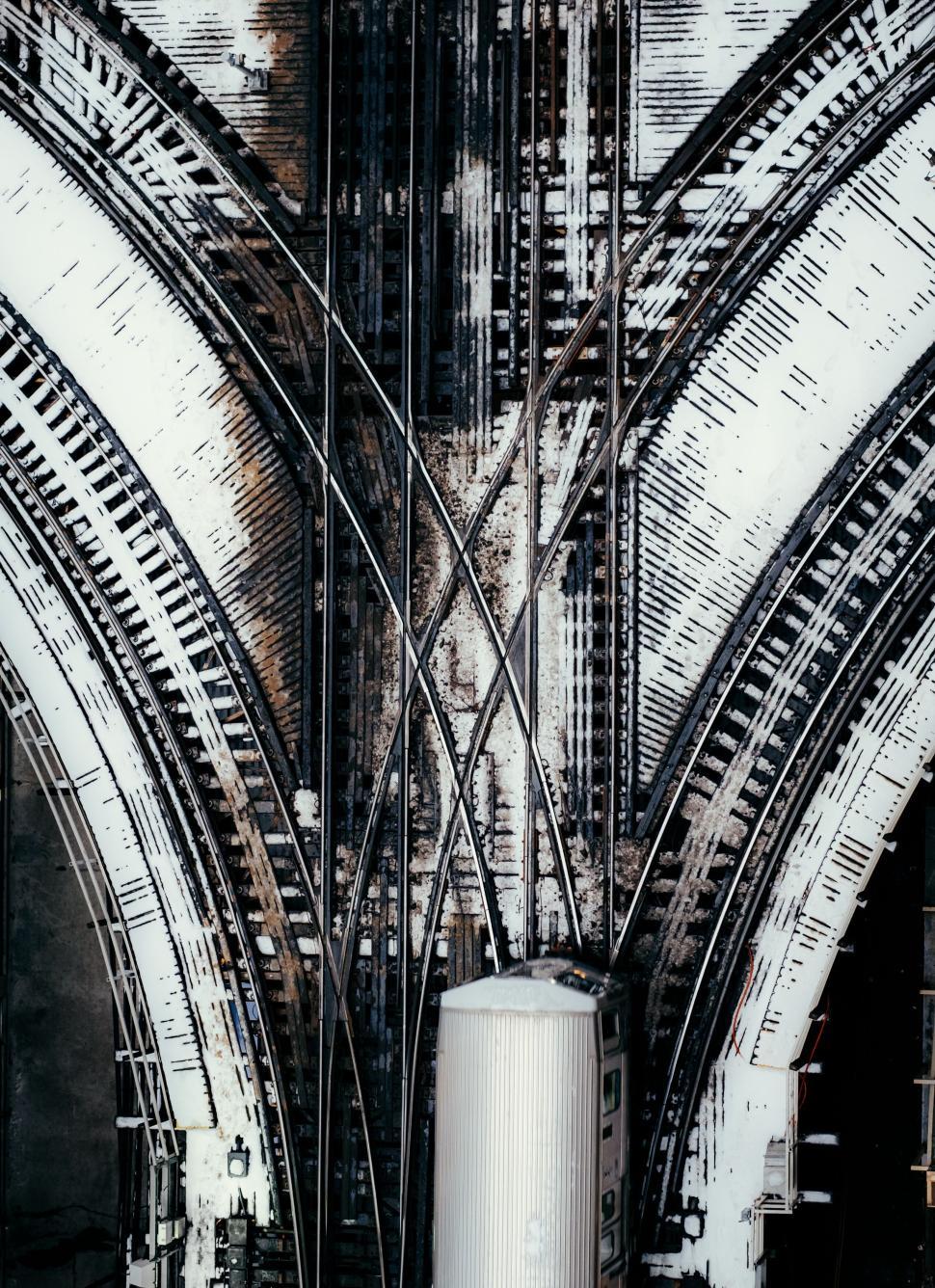 Free Image of Snowy railroad tracks converging into a main station hub. 