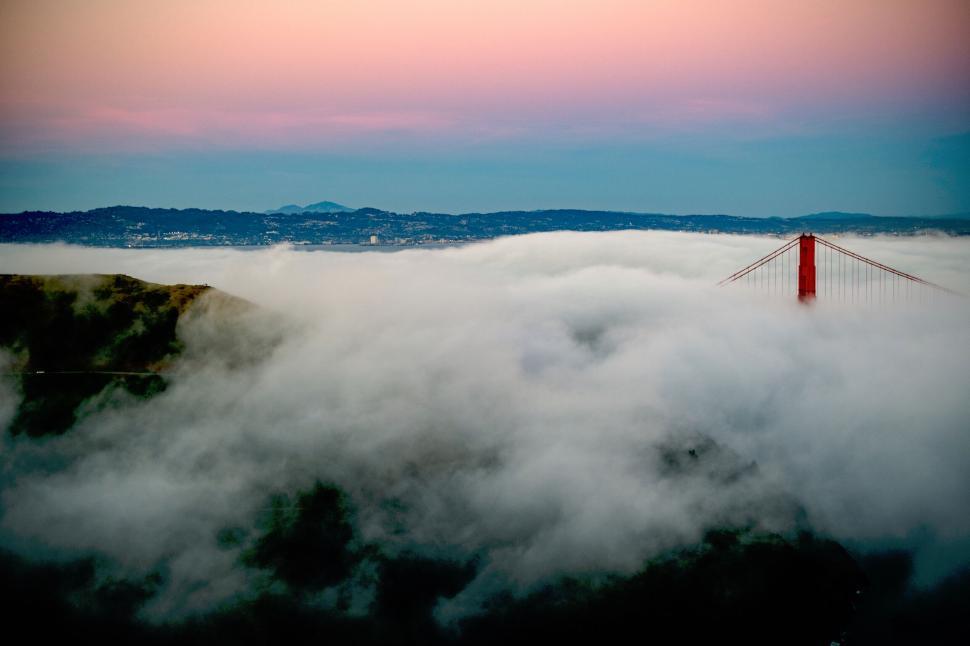 Free Image of Golden Gate Bridge piercing through the early morning fog. 