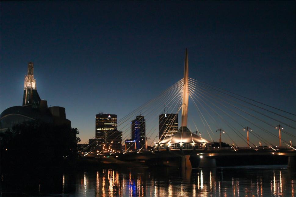 Free Image of Night view of modern bridge with illuminated cityscape. 