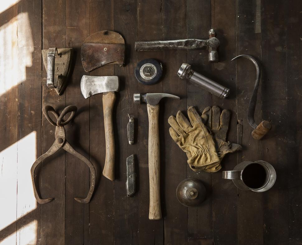 Free Image of Various hand tools and accessories on wooden surface 