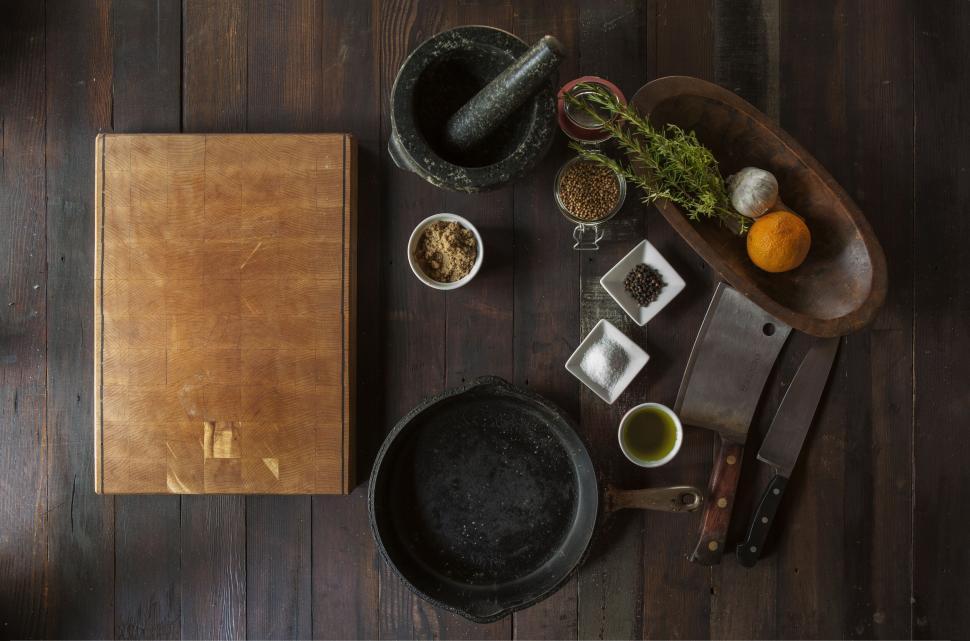 Free Image of Various kitchen tools and ingredients on wooden surface 