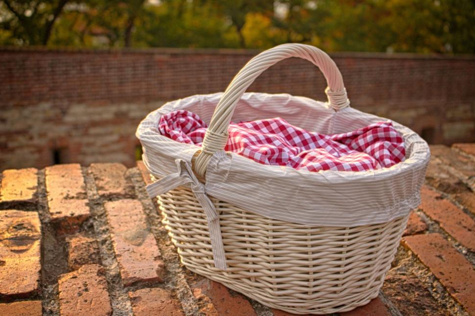 Free Image of Close-up of picnic basket with plaid cloth outdoors 