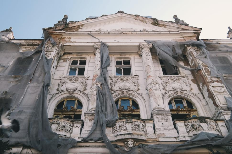 Free Image of Old, ornate building facade captured from below 