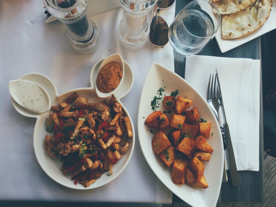 Free Image of Plates of delicious food on a white table setting 