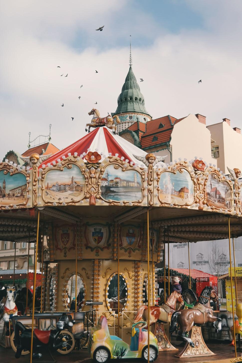 Free Image of Vintage carousel at a fair with a picturesque backdrop 