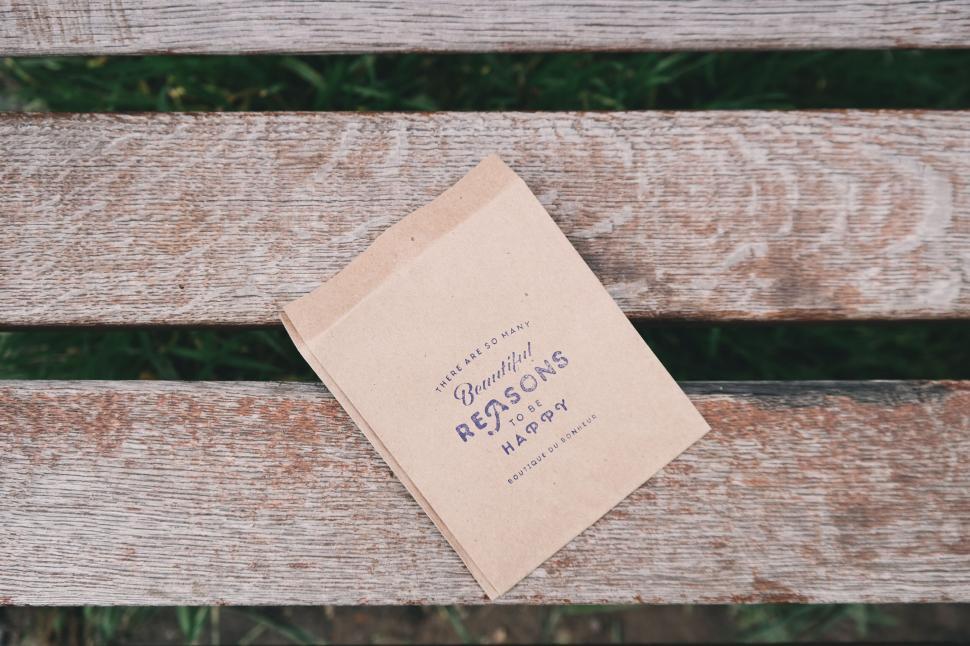 Free Image of Brown paper envelope on a rustic wooden bench 