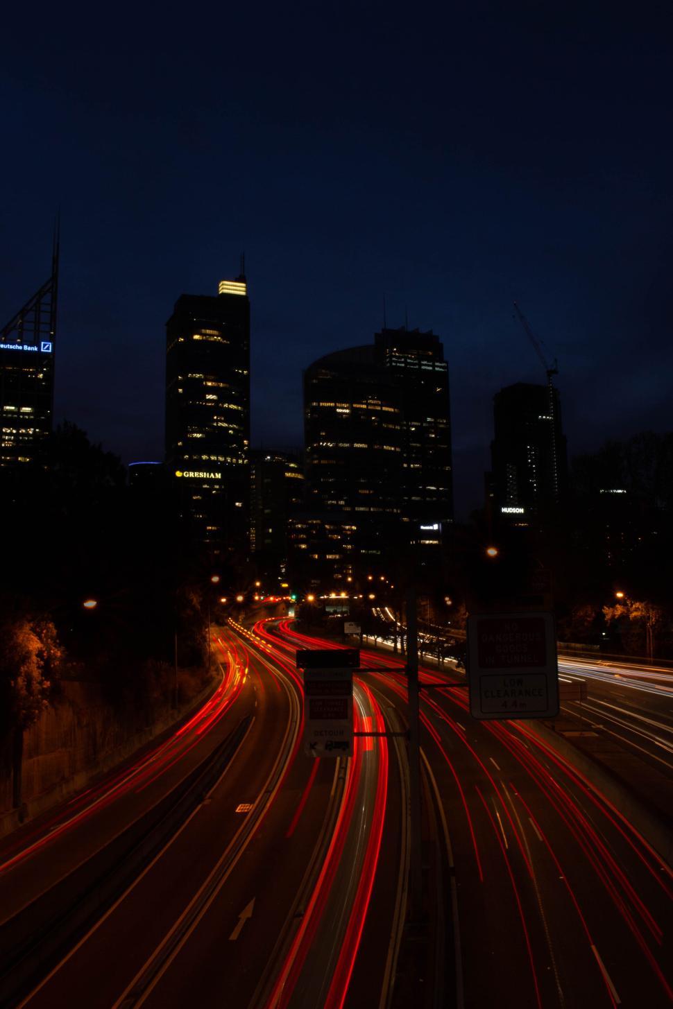 Free Image of Night cityscape with light trails on busy highway. 