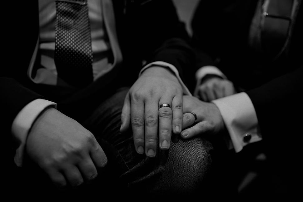Free Image of Couple holding hands with wedding rings on fingers. 