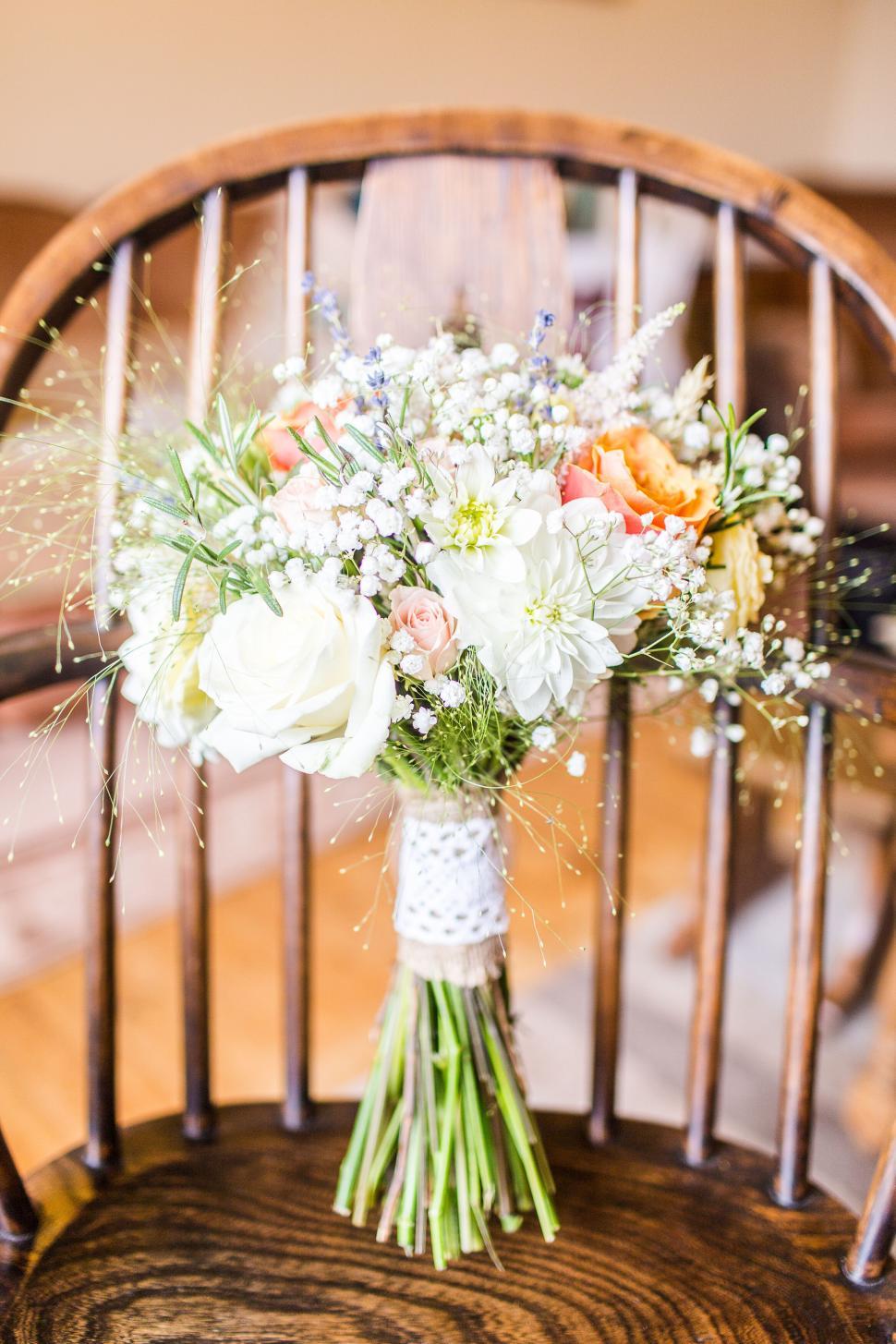 Free Image of Floral bouquet resting on a wooden chair indoors 