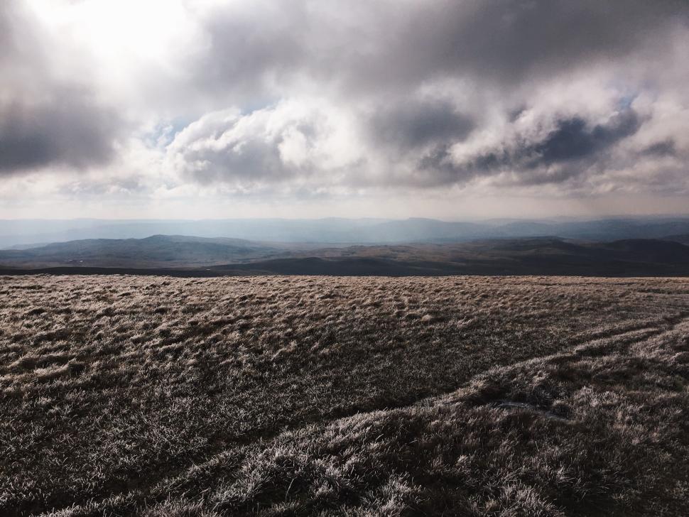 Free Image of Frosty field under a cloudy sky landscape scenery 