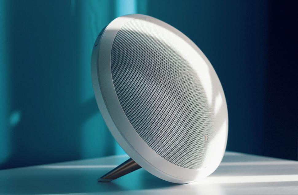 Free Image of Modern sleek speaker on a white table with blue light 
