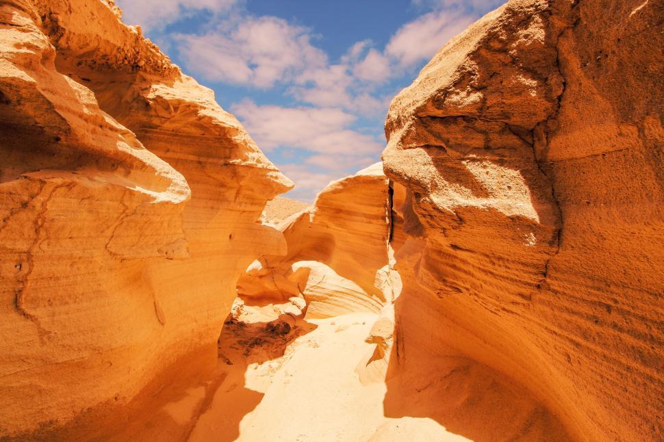 Free Image of Stunning sandstone formations under bright blue sky 