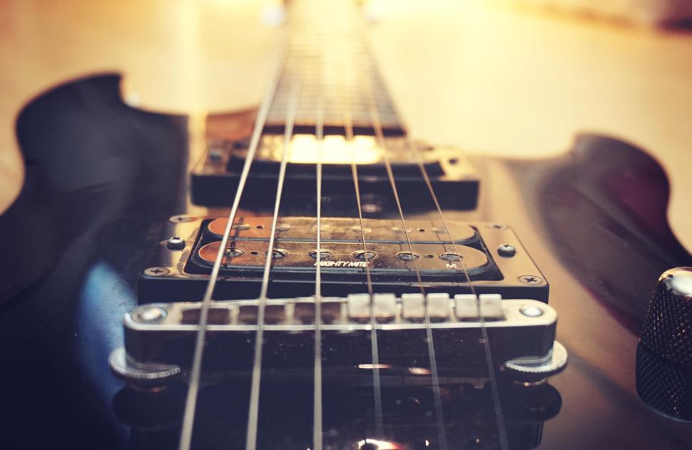Free Image of Close-up of an electric guitar s strings and pickups. 