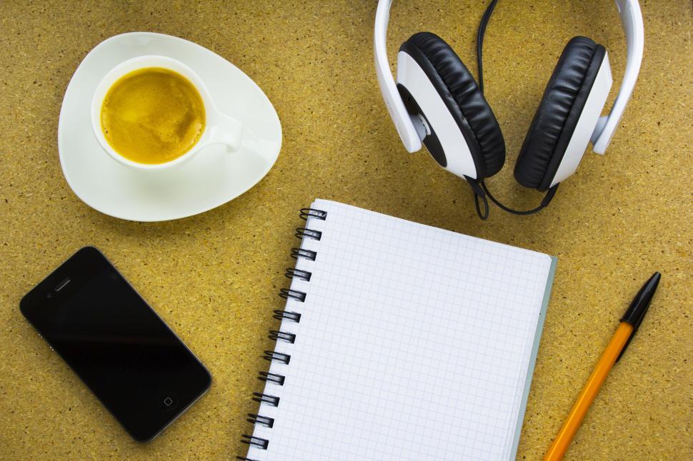 Free Image of Work essentials coffee, notebook, phone, headphones 